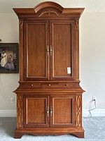 Full frontal view of armoire closed showing overall design and condition