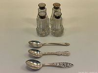Group shot of four shakers and three spoons