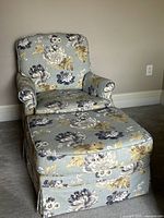 Front view of floral lounge chair with ottoman attached