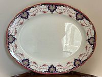 Full view of platter front showing decorative border and overall condition