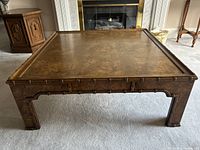 Front view of square burled walnut coffee table