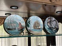 Front view of all three Royal Doulton Maritime plates on display shelf