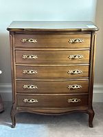 Front view showing four drawers and brass hardware