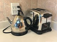 Electric kettle and toaster side by side on countertop
