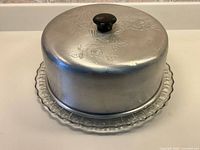 Full view of aluminum cake carrier on glass plate
