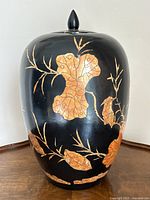 Front view of lidded ginger jar showing bird and leaf motifs