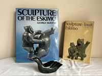 Front view of sculpture with two books standing behind