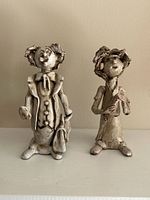 Front view of both Bencini Italy ceramic figurines
