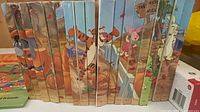 Row of 18 Winnie the Pooh hardcover books showing continuous spine artwork