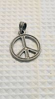 Front view of circular stainless steel peace symbol charm with bail
