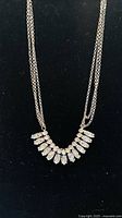 Full view of silvertone double-chain necklace with rhinestone fringe