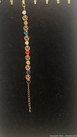 Full view of brass bracelet with crystals and extender chain