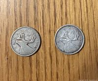 Obverse view of both coins showing caribou design and dates