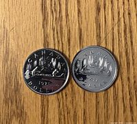 Reverse of both dollars displaying Voyageur canoe design and dates 1977 & 1978