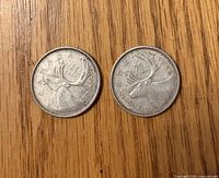 Reverse view of both 1965 Canadian quarters showing caribou design