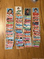 Fronts of three stacks of 1974-75 O-Pee-Chee cards displaying various player fronts