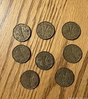 Eight 1943 Canadian 5-cent tombac coins showing reverse torch and V design