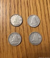 Obverse and reverse of four Canadian dimes dated 1942-1945