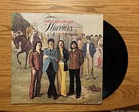 Front cover and partially visible vinyl disc