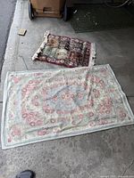 Both rugs laid out showing overall designs