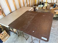 Overview of three folding tables side by side showing tops and metal legs