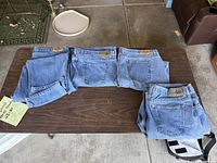 Four pairs Kirkland jeans folded on table