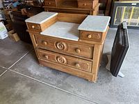 Front view of dresser showing marble pieces and drawer arrangement