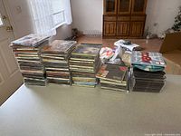 Overview of four stacks of CDs on countertop