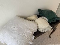 Group of four pillows on bench showing variety and condition