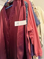 Group of six garments on hangers showing colors and styles