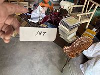 Overview of assorted items on table including turkey tray, CDs, teddy bear, small chair, jigsaw puzzle and decorations