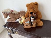 Group shot of all plush toys and wood bears on table