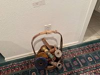 Basket holding mixed wooden spools