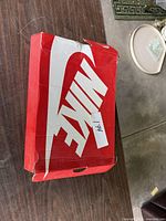 Closed red Nike box showing logo