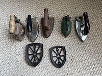 Five irons and two trivets laid out on carpet