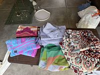 Group of folded towels and blanket on table