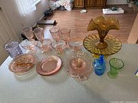 Group view showing all colored depression and vaseline glass pieces