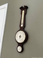 Full view of wooden wall weather station hung on wall