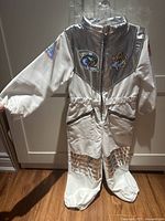 Front view of jumpsuit hanging