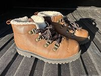 Side view of both boots showing uppers, laces, and soles