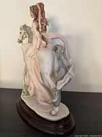 Front view of figurine showing lady, horse, reins, base