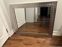 Full view of the rectangular mirror leaning against wall