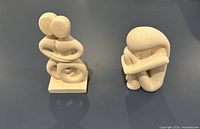 Front view of both sculptures displaying overall form and color