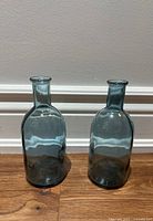 Front view of both matching glass vases standing side by side