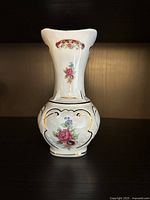 Front view of bud vase showing floral motif and gold accents