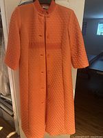 Full front view of orange quilted robe