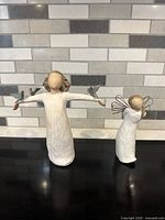 Front view of both figurines showing overall design and condition