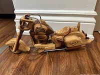 Left side view of entire wooden motorcycle model