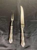 Full view of knife and fork with sterling handles