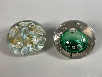 Both paperweights side by side showing overall designs